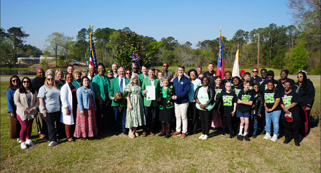Group Of Community Members around a tree